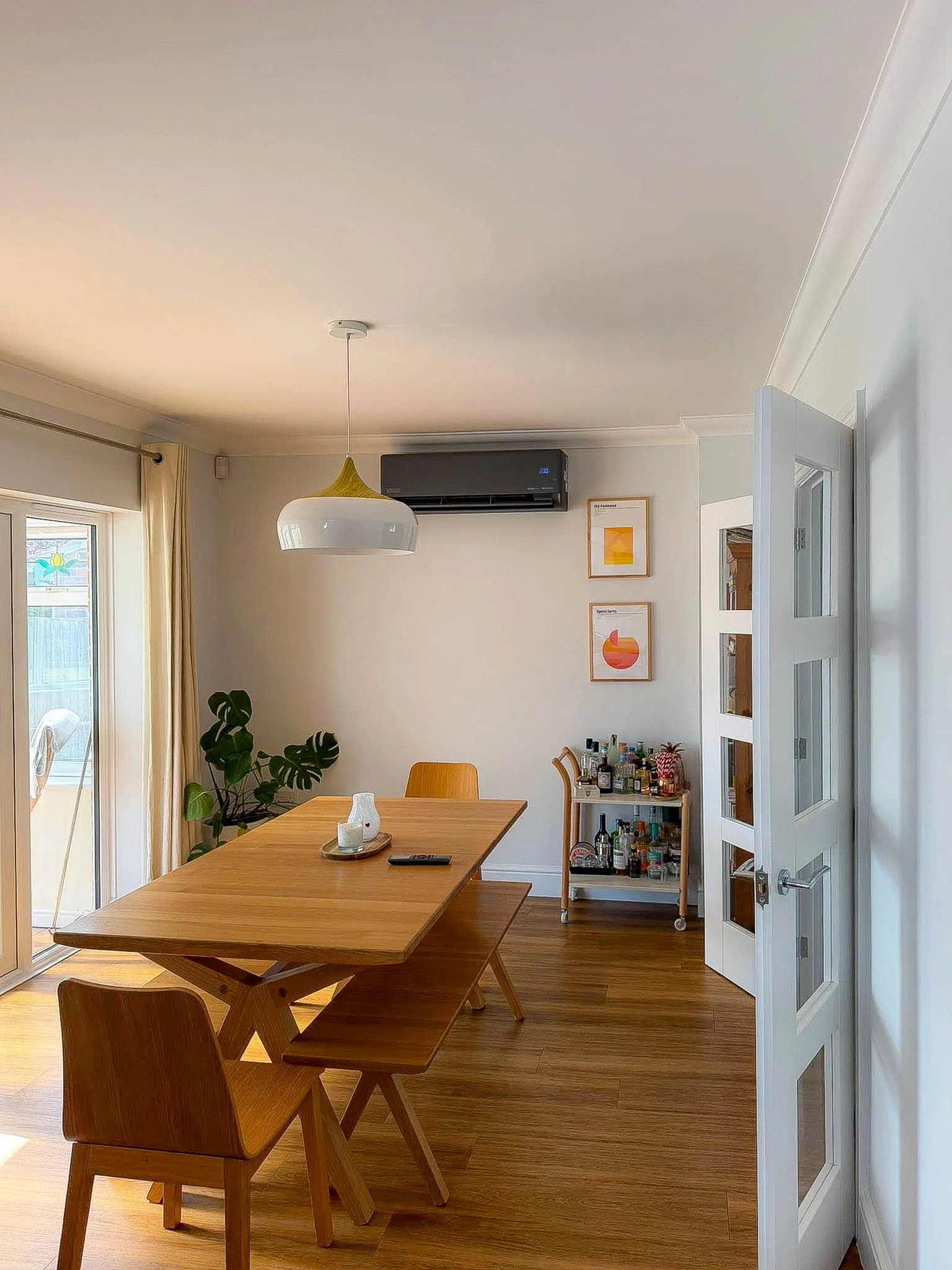 Open-Plan Dining - Discreet high-wall unit keeping a sunlit dining space comfortable. by The Cooling Guy